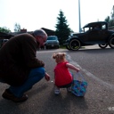 Papa helping Adelaine pick up candy.